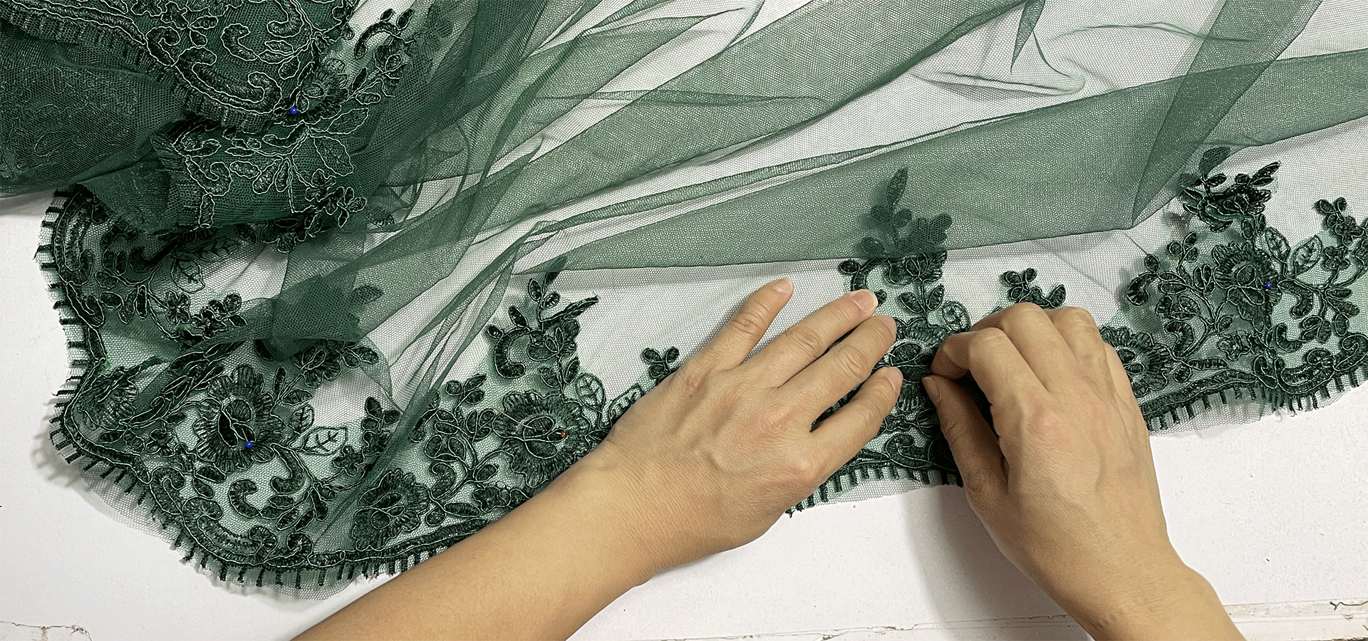 Behind the Dress | Hand-Placing Lace on a Dark Green Tulle Gown