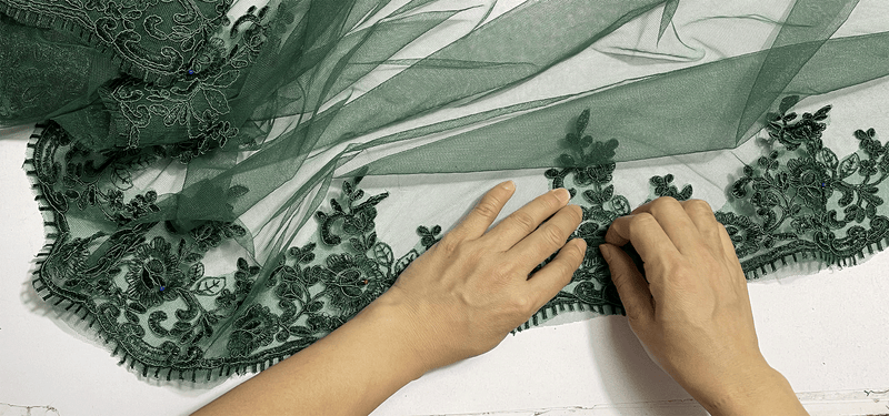 Behind the Dress | Hand-Placing Lace on a Dark Green Tulle Gown