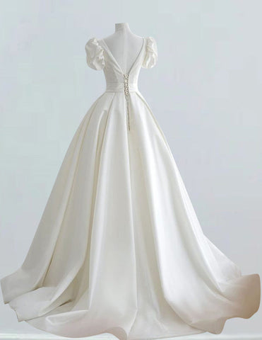 a white wedding dress on a mannequin