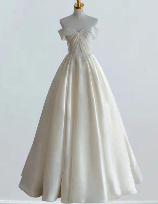 a white wedding dress on a mannequin