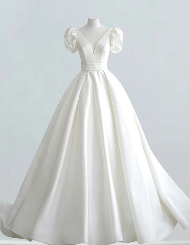 a white wedding dress on a mannequin