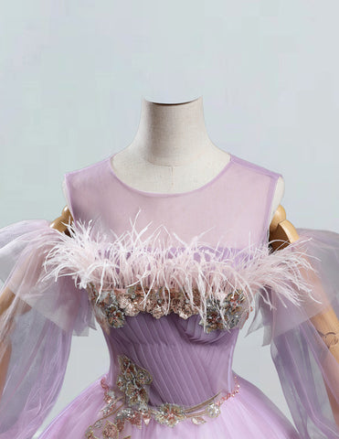 a mannequin dressed in a pink dress with feathers