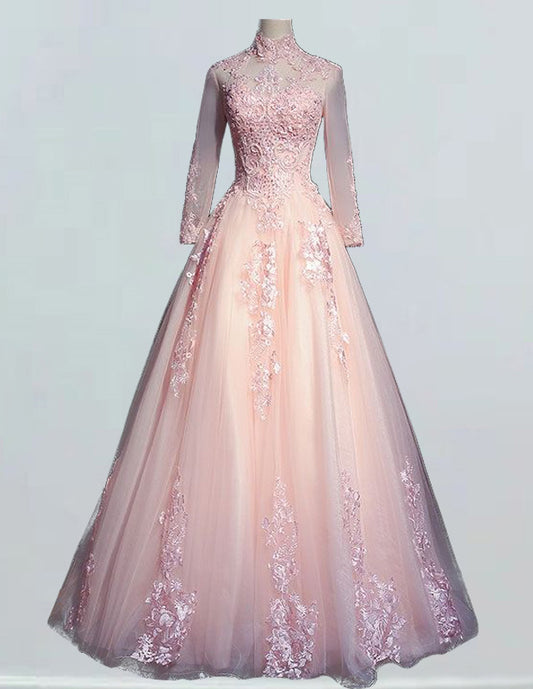 a pink ball gown with long sleeves and flowers on the skirt