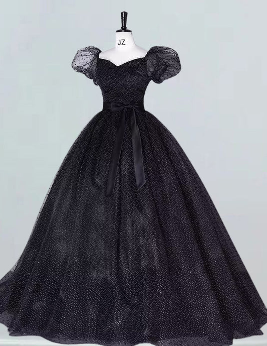 a black dress on a mannequin with a bow