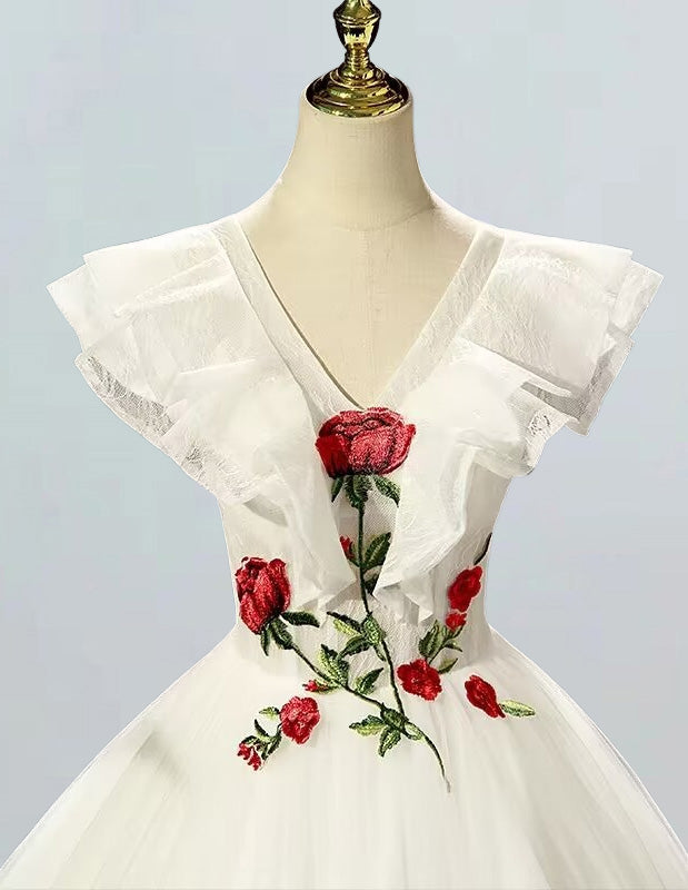 a white dress with red roses on it