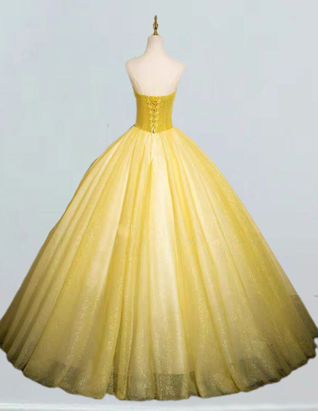 a yellow ball gown on a mannequin