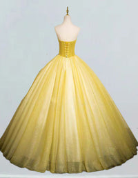 a yellow ball gown on a mannequin