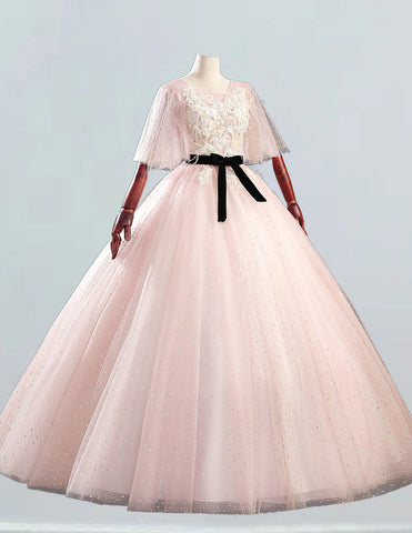 a mannequin dressed in a pink dress with a black sash