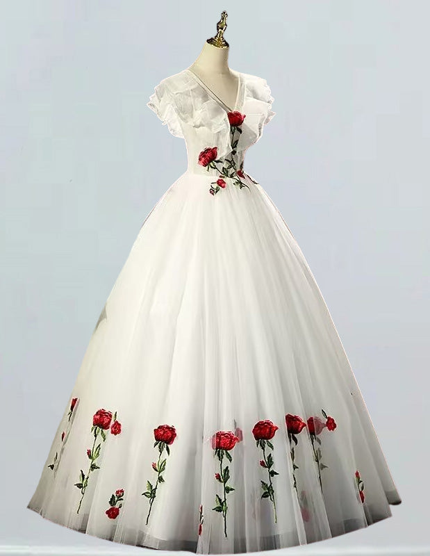 a white dress with red roses on it