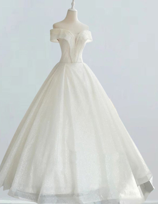 a white wedding dress on a mannequin