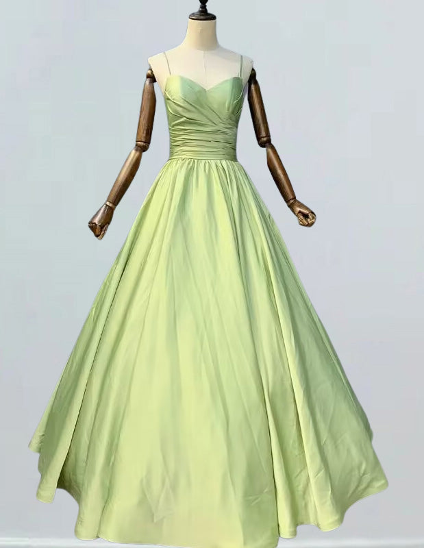 Elegant green pleated prom gown with spaghetti straps, perfect for formal events and evening parties0