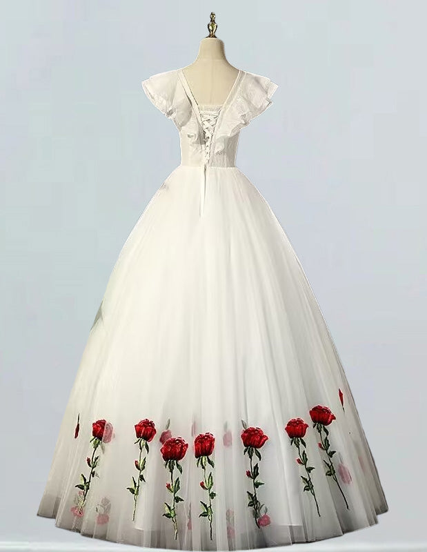 a white dress with red roses on it