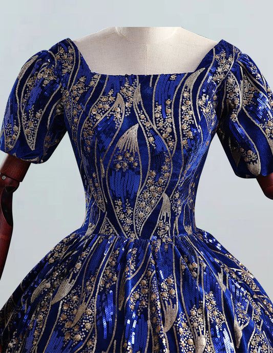 a blue and gold dress on a mannequin