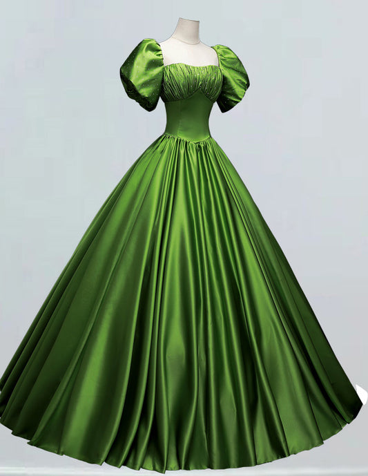 a green dress with puffy sleeves on a mannequin