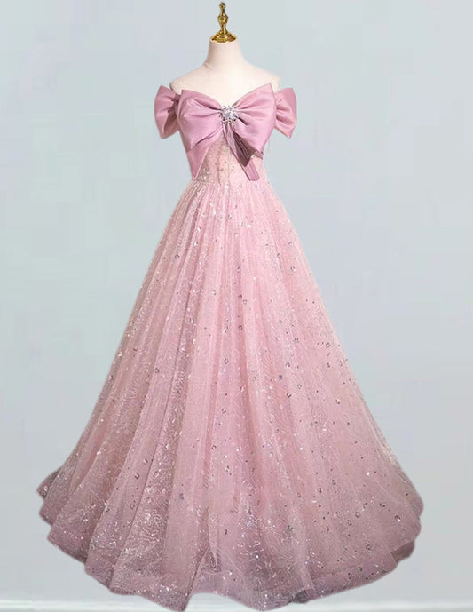 a pink ball gown with a large bow on the back