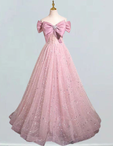 a pink ball gown with a large bow on the back